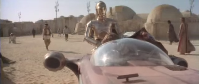 Luke, Obi Wan, R2D2 y C3PO detienen su vehículo antigravitatorio en Mos Eisley tras superar el control de las tropas imperiales